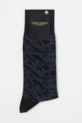 Pandemonium black men's luxury socks by Peper Harow, featuring a quirky navy pattern and navy toe and heel in packaging.