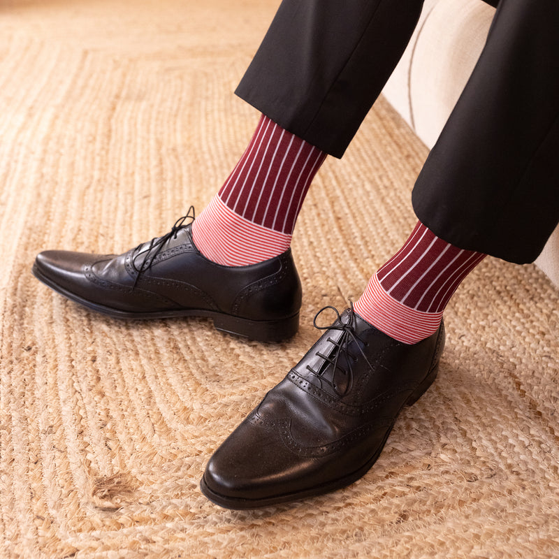 men in black smart shoes wearing oxford stripe burgundy socks