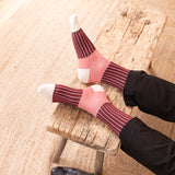 men in black smart shoes wearing oxford stripe burgundy socks