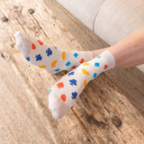 woman wearing royal flush beige socks at home sitting on the couch wooden floor