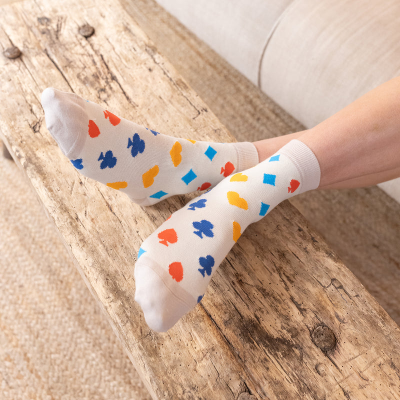 woman wearing royal flush beige socks at home sitting on the couch wooden floor