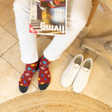 men wearing red Royal Flush Men's Socks in the kitchen holding magazine white trainers wearing white pants