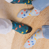 woman and couple wearing royal flush blue socks in the kitchen at home