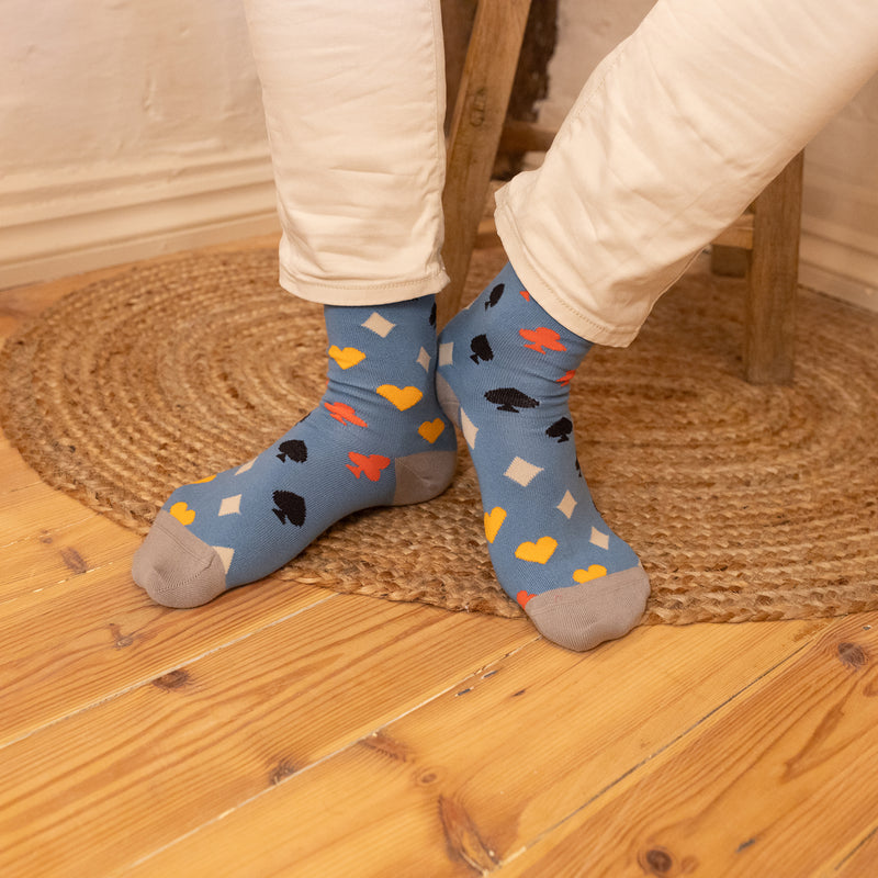 men wearing blue Royal Flush Men's Socks in the kitchen wearing white pants