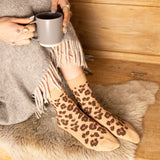 woman wearing beige leopard socks with brown spots at home luxury comfort quality