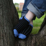 Man wearing Peper Harow black Dash men's luxury trainer socks in a tree