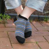 Close up of man wearing Peper Harow black Multistripe men's luxury trainer socks outdoors