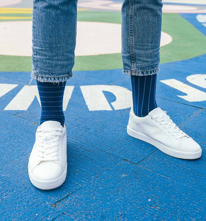 Man wearing navy Dash recycled socks from Peper Harow.