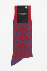Maelstrom red men's luxury socks by Peper Harow, featuring a quirky purple pattern and purple toe and heel in packaging.