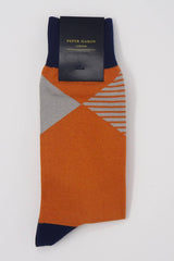 Navy socks with a red cuff, heel and toe, with a grey diamond shaped pattern around the ankle in packaging.