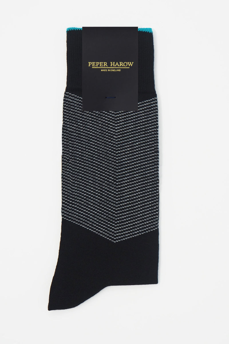 A pair of Onyx men's chevron socks in packaging, with a white V striped pattern down the calf, and a turquoise line circling the top of the cuff
