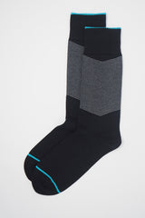 A pair of Onyx men's chevron socks, with a white V striped pattern down the calf, and a turquoise line circling the toes and the top of the cuff