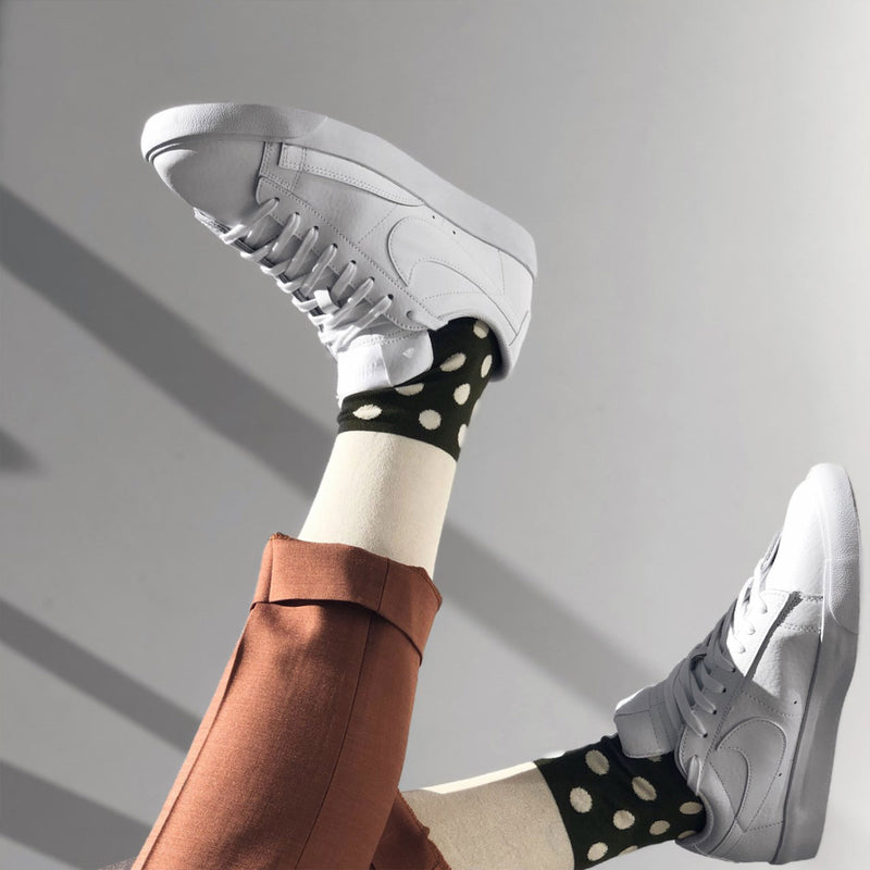 Gentleman with brown trousers and white trainers wearing Cream Mayfair luxury socks by Peper Harow
