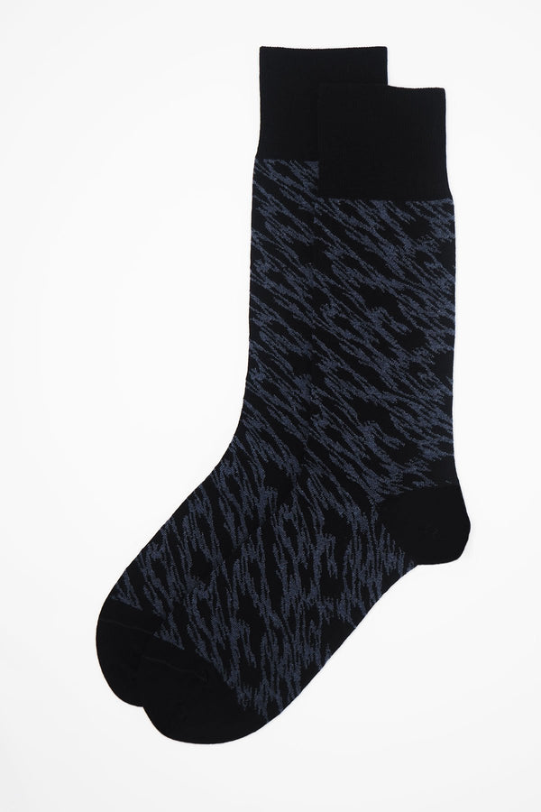 A pair of Pandemonium black men's luxury socks by Peper Harow, featuring a quirky navy pattern and navy toe and heel.