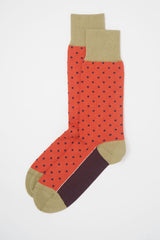 A pair of orange pin polka men's socks with purple polka dots and a beige heel, toe and cuff