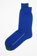 A pair of cobalt blue square mile men's socks with a green toe and cuff line, and a white line down the side of the foot