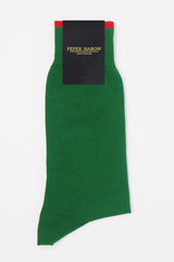A pair of emerald green square mile men's socks in packaging