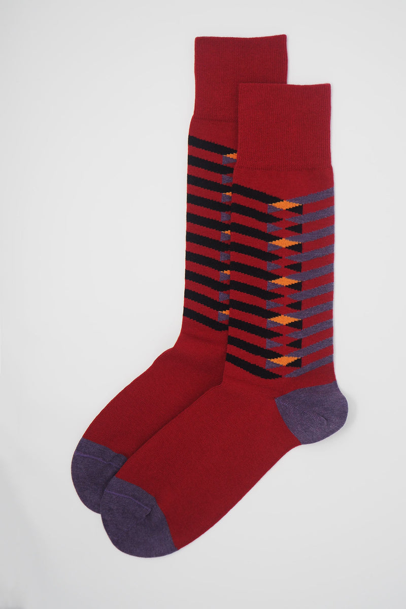 A pair of Symmetry red men's luxury socks by Peper Harow, featuring stylish purple and black stripes, and a purple heel and toe.