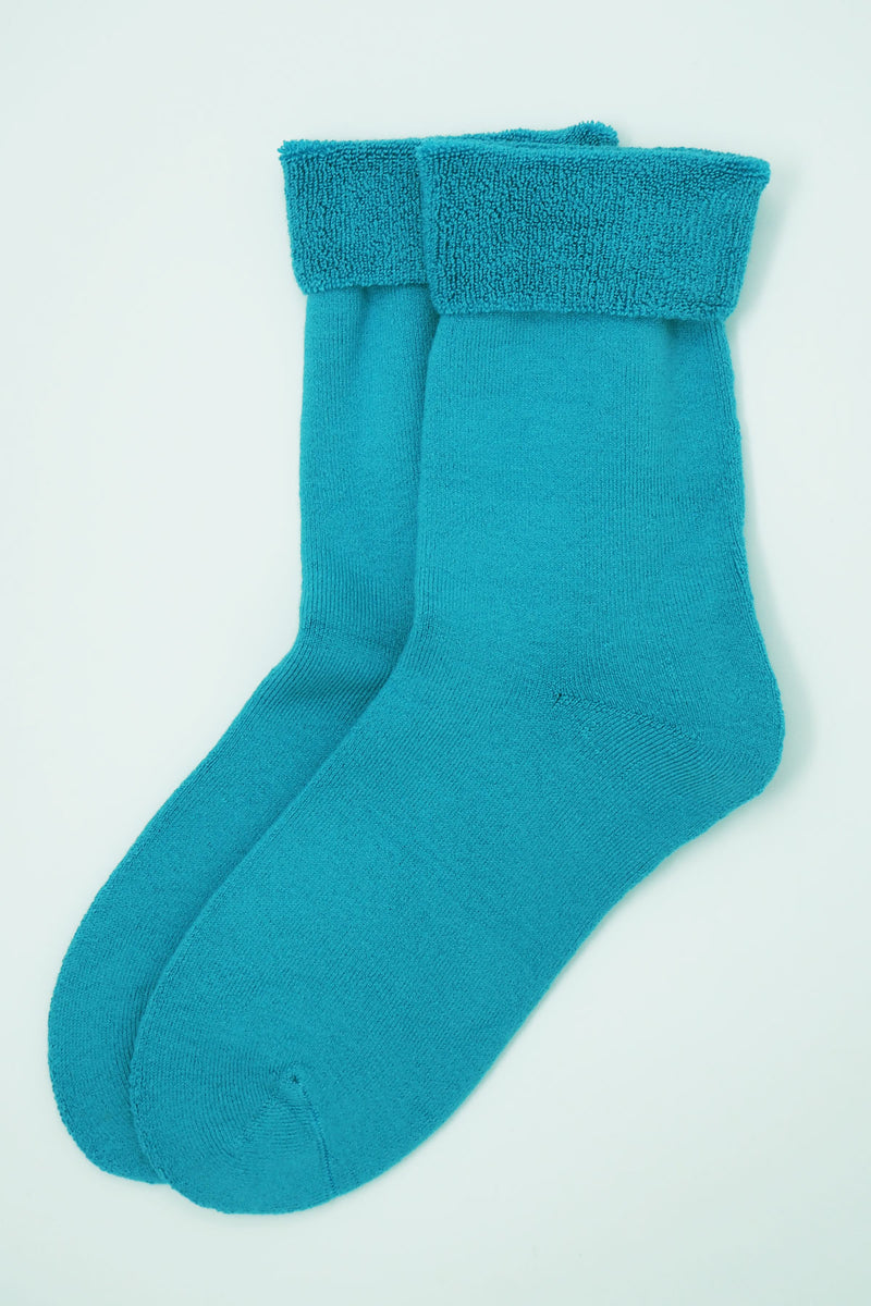 Two pairs of Peper Harow men's bright aqua Plain luxury bed socks  showing fluffy inside