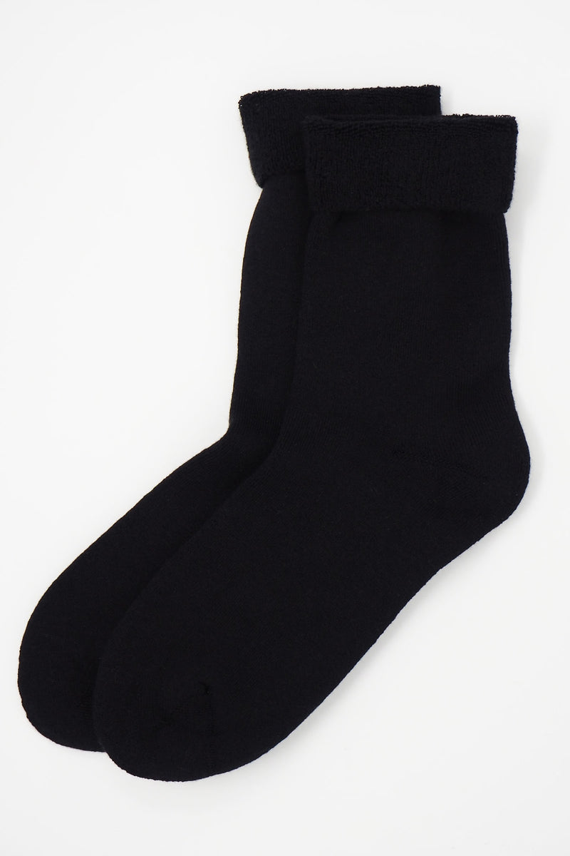 Two pairs of Peper Harow men's black Plain luxury bed socks showing fluffy inside