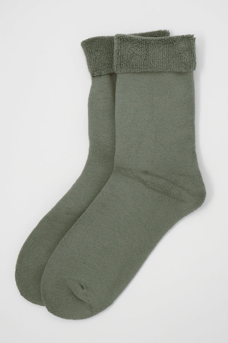 Two pairs of Peper Harow women's grey Plain luxury bed socks showing fluffy inside