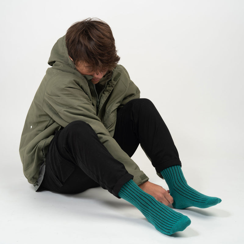 Man wearing Peper Harow green Recycled Ribbed men's luxury socks