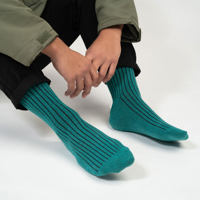 Man wearing Peper Harow green Recycled Ribbed men's luxury socks