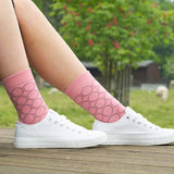 Woman wearing white trainers and pink Beehive luxury women's socks