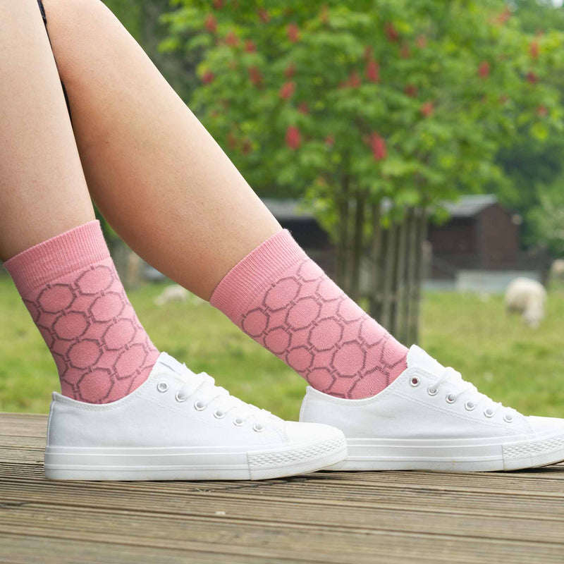 Woman wearing white trainers and pink Beehive luxury women's socks