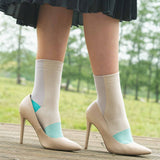 Woman wearing black skirt and Anne beige women's luxury socks by Peper Harow