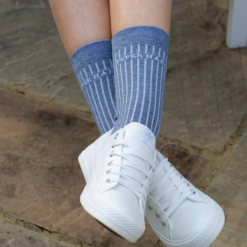 Woman wearing white trainers and blue Recycled cotton women's socks