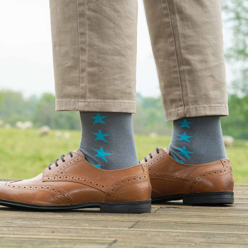 Man wearing brown shoes, tan trousers and Peper Harow grey Starfall men's luxury socks