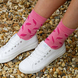 Woman wearing white trainers and pink Leaf women's luxury socks by Peper Harow