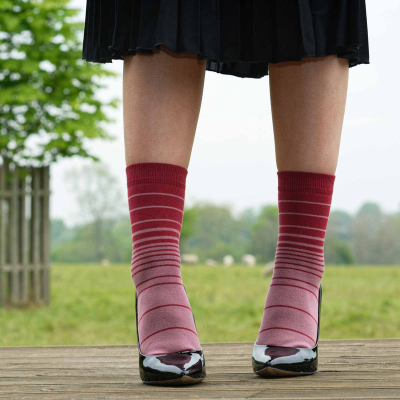 Woman in black skirt and high heels wearing Peper Harow musk Retro Stripe women's luxury socks