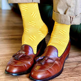Smart man wearing tan shoes and trousers and Peper Harow butterscotch Polka Stripe mens luxury socks
