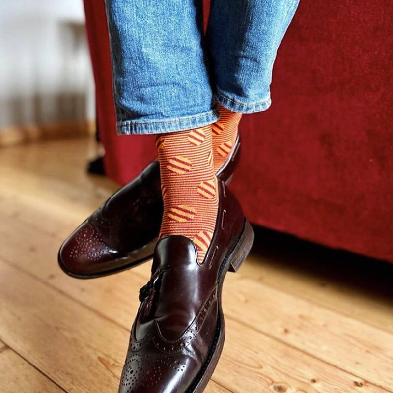 Man in jeans wearing Peper Harow garnet Polka Stripe luxury socks