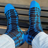 Man wearing sable Houndstooth men's luxury socks by Peper Harow and blue jeans