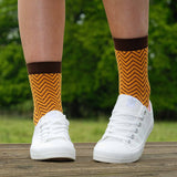 Woman wearing white trainers and mustard Zigzag womens luxury socks by Peper Harow