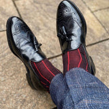 Man wearing blue trousers and black loafers wearing black Pin Stripe luxury socks by Peper Harow