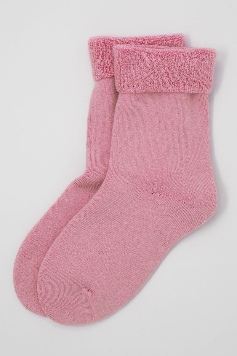 Two pairs of Peper Harow women's pink Plain luxury bed socks showing fluffy inside