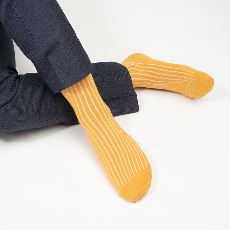 Man wearing Peper Harow mustard Recycled Ribbed men's luxury socks